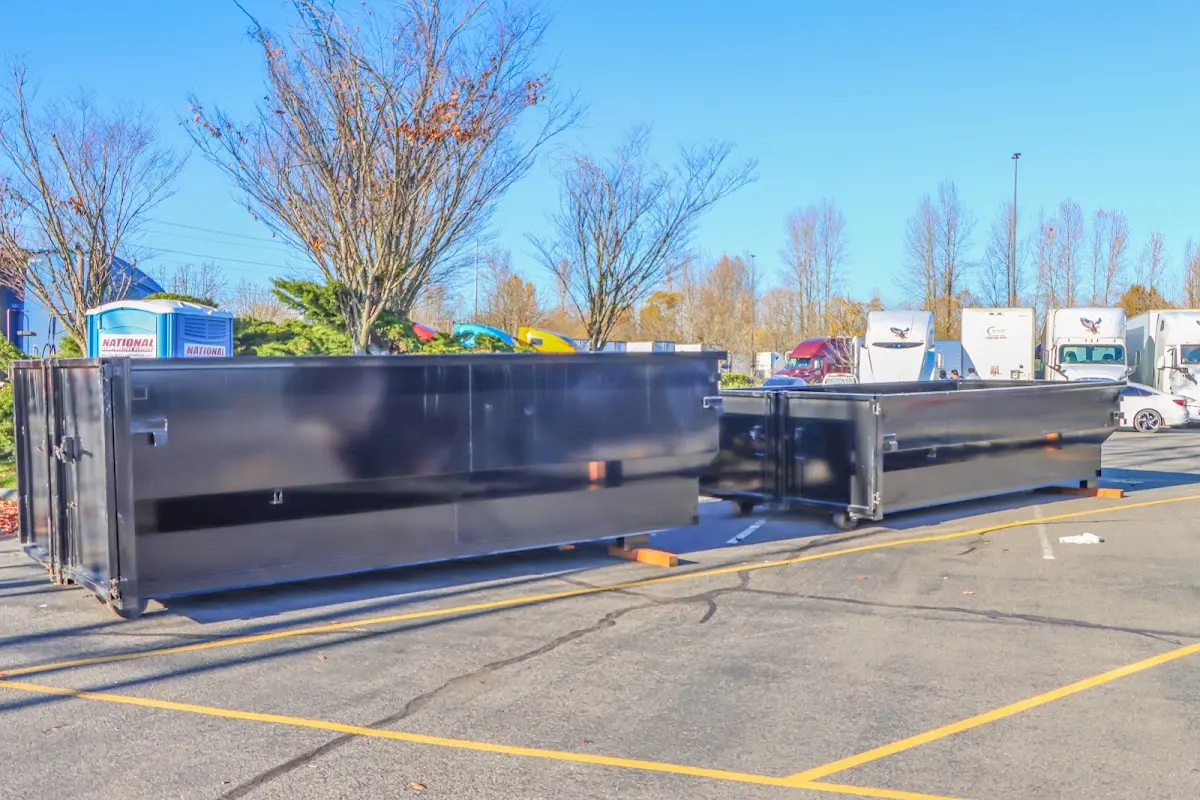 Professional dumpster rental service with roll-off container on residential driveway in Hinesville